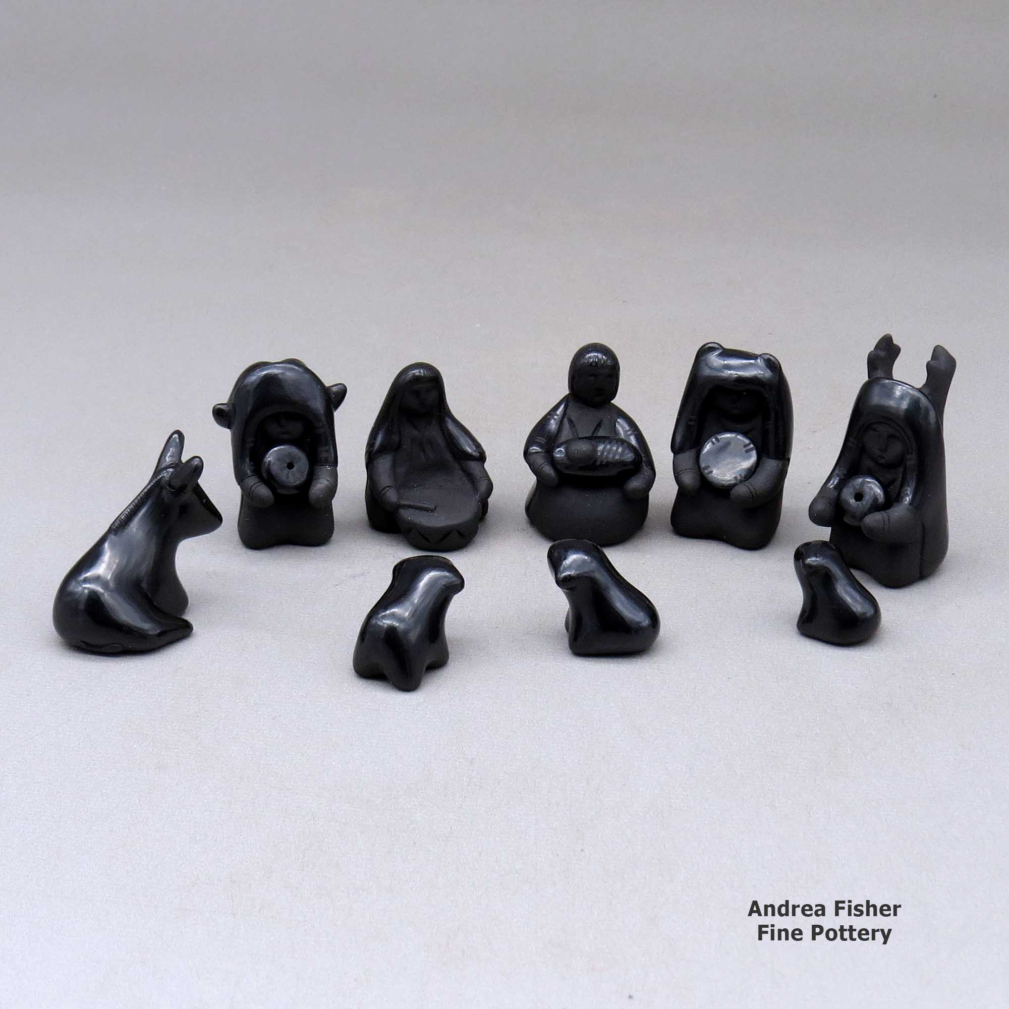 Click or tap to see a larger view A thirteen piece miniature matte and polished black Nativity scene with Navajo wise men made by Linda Askan of Santa Clara
