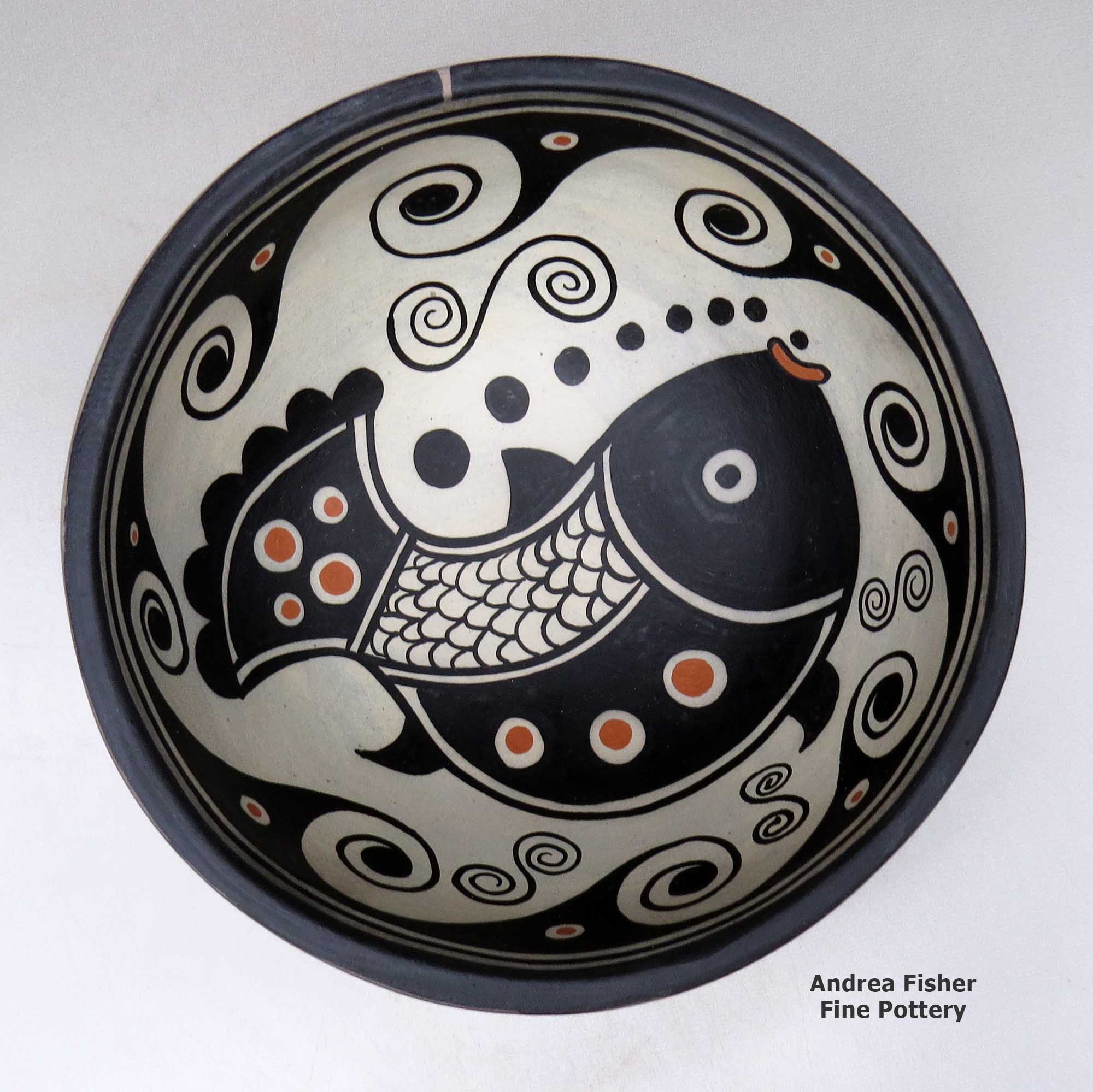 Click or tap to see a larger view A polychrome bowl decorated with a fish and geometric design inside, and with a spiral and geometric design outside made by Thomas Tenorio of Santo Domingo