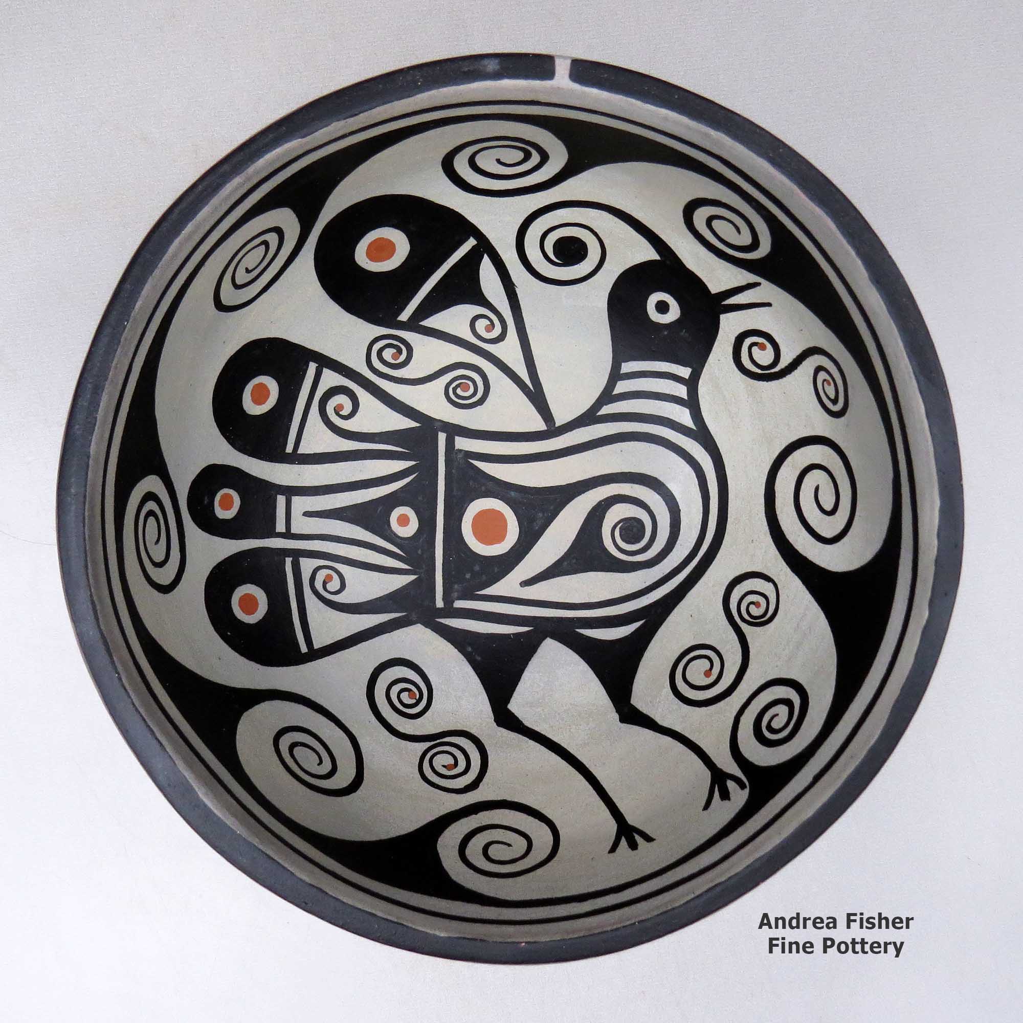 Click or tap to see a larger view A polychrome bowl decorated with a bird and geometric design inside, and with a spiral and geometric design outside made by Thomas Tenorio of Santo Domingo