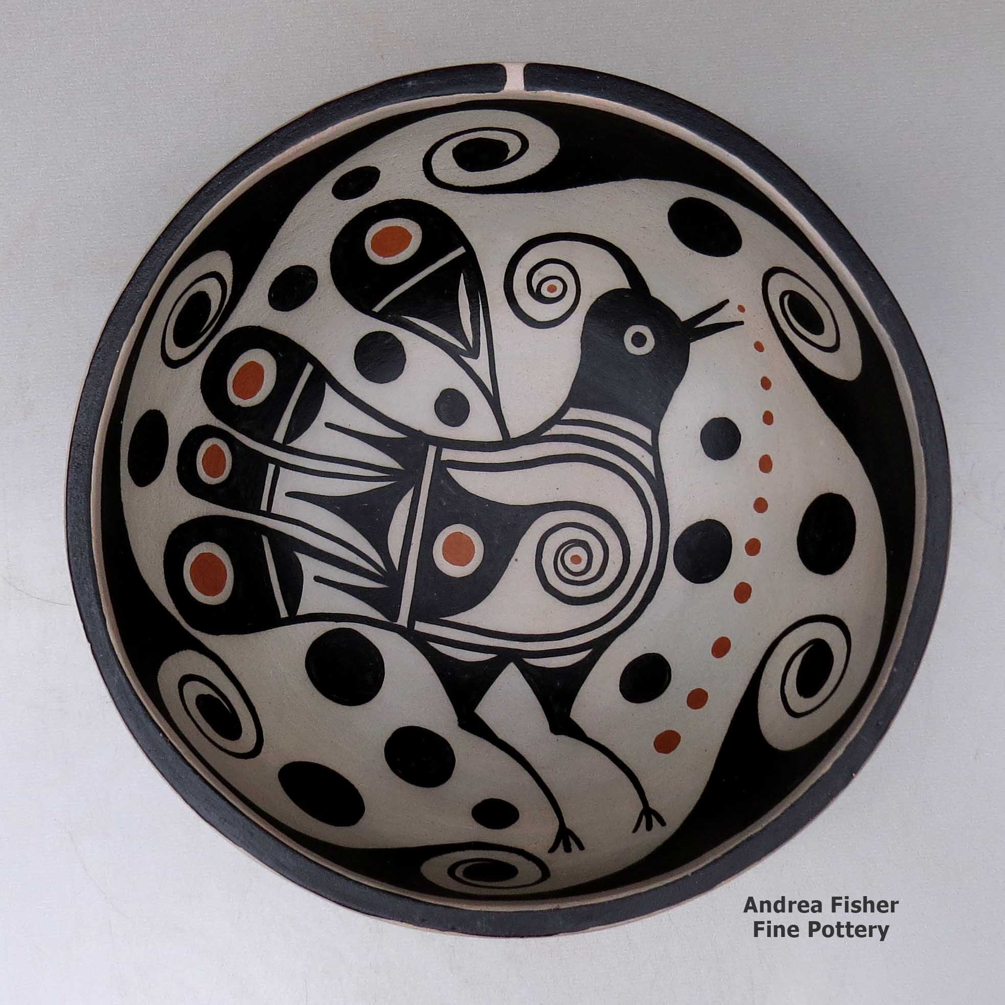 A polychrome chili bowl decorated with a bird and water symbol geometric design inside, and a water symbol geometric design outside made by Thomas Tenorio of Santo Domingo
