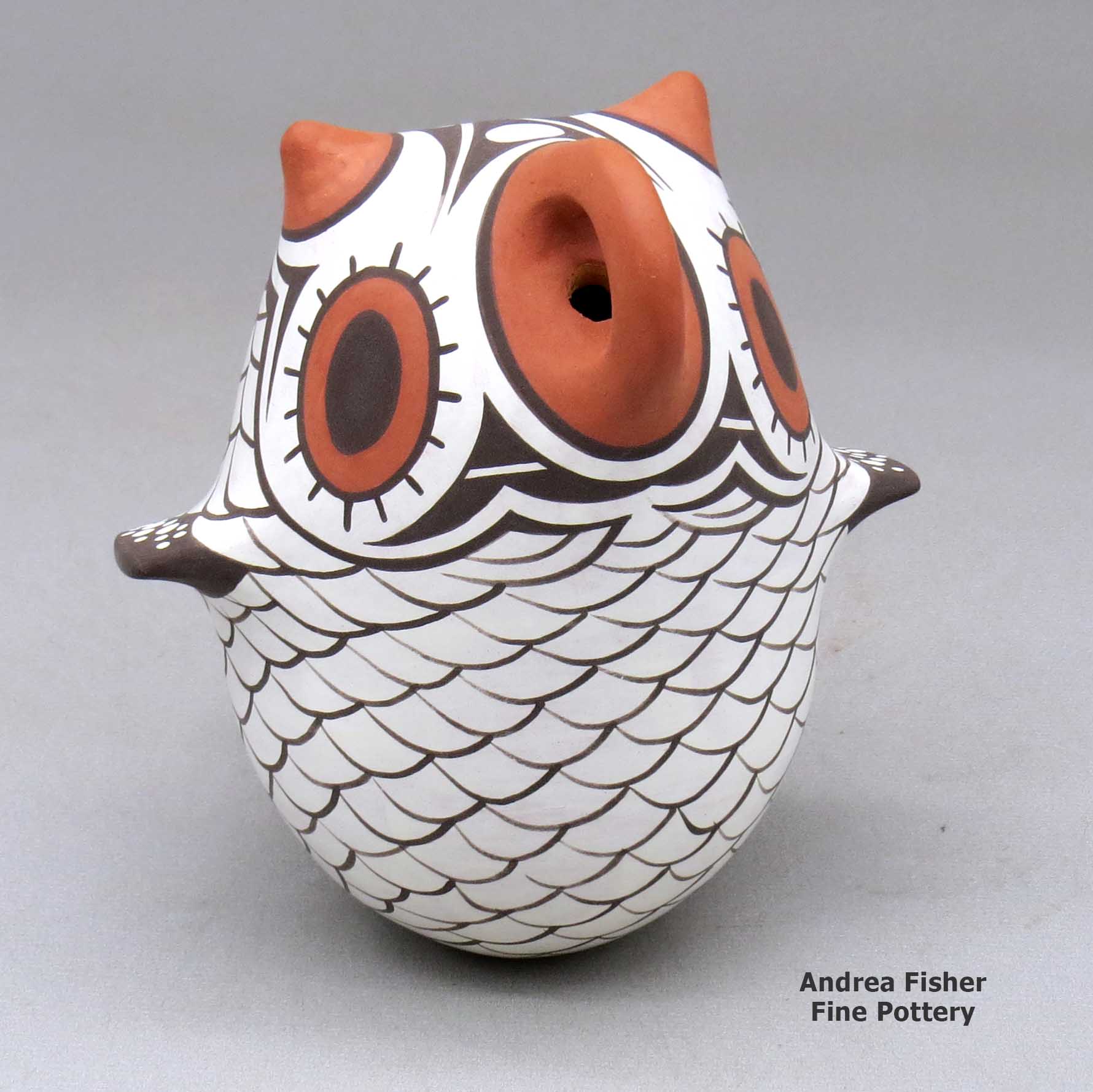 Click or tap to see a larger view A polychrome owl figure decorated with a bird element design made by Anderson Jamie Peynetsa of Zuni