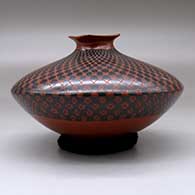 A black on red seed pot with a short neck and square rim, decorated with a checkerboard geometric design, click or tap to see a larger version