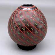 A polychrome jar decorated with a tiny squares and geometric design
 by Cesar Dominguez of Mata Ortiz and Casas Grandes