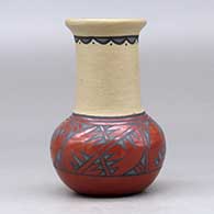 A small polychrome vase decorated with a geometric design around the shoulder, upper neck and inner rim, click or tap to see a larger version