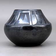 A black on black jar decorated with a four-panel feather and geometric design above the shoulder, Tag indicates it was first sold at the 1939 Golden Gate International Exposition, click or tap to see a larger version