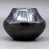 A black on black jar decorated with a four-panel feather and geometric design above the shoulder, Tag indicates it was first sold at the 1939 Golden Gate International Exposition, click or tap to see a larger version