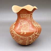 A red jar with an organic opening and a lightly carved and sgraffito kokopelli, spiral, feather and geometric design around the body
 by Gabriel Cajero of Jemez