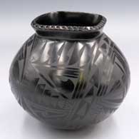 Black-on-black jar with a flared square notched rim and a 4-panel geometric design
 by Oscar Quezada of Mata Ortiz and Casas Grandes
