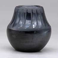 A small black on black jar decorated with a band of feathers design above the shoulder, click or tap to see a larger version