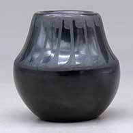 A small black on black jar decorated with a band of feathers design above the shoulder, click or tap to see a larger version