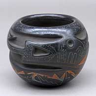 A polychrome bowl decorated with an avanyu design carved around the body and with a sgraffito and painted bear, mudhead and geometric design in between
 by Ergil Vallo of Acoma