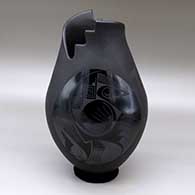 A black on black on black vase with an organic cut opening and decorated with a two panel geometric design
 by Lydia Quezada of Mata Ortiz and Casas Grandes
