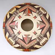 A polychrome flat-top Sikyatki-style seed pot decorated with a four-panel Awatovi katsina and geometric design
 by James Nampeyo of Hopi