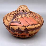Click for a larger view A polychrome melon jar carved and painted with a longhair kachina, feather and geometric design
 by Thomas Polacca of Hopi