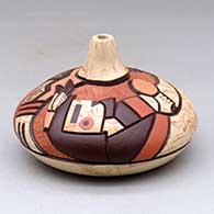 A polychrome seed pot decorated with a carved, sgraffito and painted pueblo dancer and geometric design, click or tap to see a larger version