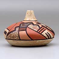 A polychrome seed pot decorated with a carved, sgraffito and painted pueblo dancer and geometric design, click or tap to see a larger version