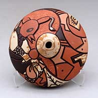 A polychrome seed pot decorated with a carved, sgraffito and painted mudhead dancer and geometric design
 by Delmar Polacca of Hopi
