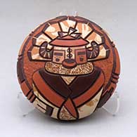 A polychrome seed pot decorated with a carved, sgraffito and painted pueblo dancer and geometric design
 by Delmar Polacca of Hopi