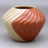 A red and tan melon jar with 24 carved ribs
 by Pauline Romero of Jemez
