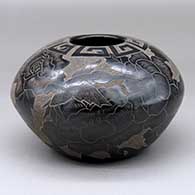 A black jar decorated with a sgraffito hummingbird, vine, flower and geometric design
 by Gwen Tafoya of Santa Clara