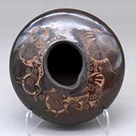 A brown jar with an organic opening and decorated above the shoulder with a sgraffito kokopelli and geometric design
 by Forrest Naranjo of Santa Clara