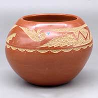 A red bowl decorated with a sgraffito avanyu and geometric design above the shoulder, plus an inlaid stone
 by Juan Tafoya of San Ildefonso
