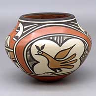 A polychrome jar decorated with a four panel roadrunner, rainbow fineline and geometric design
 by Lois Medina of Zia