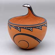 A polychrome bowl decorated with a lizard applique on the rim and painted with a lizard and geometric design around the body
 by Anderson Peynetsa of Zuni