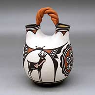 A polychrome wedding vase with a twisted bridge and decorated with a rosette, deer-in-his-house and geometric design
 by Carlos Laate of Zuni