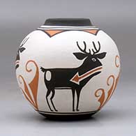 A small polychrome jar with a raised rim and a four panel deer with heart line and geometric design, click or tap to see a larger version