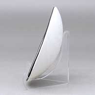 A shallow black on white bowl decorated with a fisherman, fish and geometric design, click or tap to see a larger version