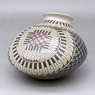 Click for a larger view A polychrome jar with a flared lip and decorated all over with a geometric design
by Martha Hernandez of Mata Ortiz and Casas Grandes