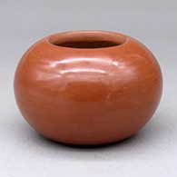 A plain polished red bowl
 by Albert and Josephine Vigil of San Ildefonso