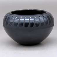 A black on black bowl decorated with a ring-of-feathers design above the shoulder
 by Helen Gutierrez of San Ildefonso