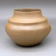 A double-shouldered buff-and-golden micaceous jar
 by Edna Romero of Taos