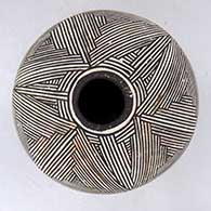 A black-on-white seed pot decorated with a fine line geometric design above the shoulder
 by Marie Z Chino of Acoma