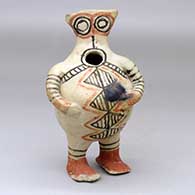 A standing polychrome figure decorated with a geometric design and fire clouds
 by Unknown of Cochiti