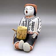 A sitting singing drummer figure decorated with a geometric design and holding a drum
 by Mary Martin of Cochiti