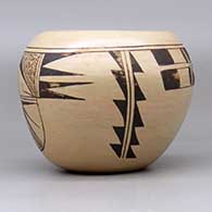 A black-on-tan bowl decorated with a two-panel bird-hanging-from-sky-band and geometric design, click or tap to see a larger version