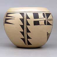 A black-on-tan bowl decorated with a two-panel bird-hanging-from-sky-band and geometric design, click or tap to see a larger version