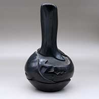 A black wedding vase carved around the body with an avanyu design, click or tap to see a larger version