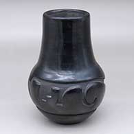 A black jar with a tall neck and carved around the shoulder with a geometric design
 by Christina Naranjo of Santa Clara