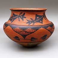 A black-on-red jar with a recurved neck and decorated above the shoulder with a four-panel geometric design and below the shoulder with a five-panel geometric design
 by Unknown of San Ildefonso