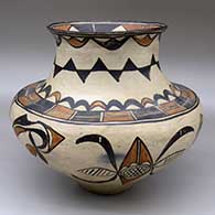 A polychrome jar decorated below the shoulder with a four-panel geometric design, and above the shoulder with a rainbow and geometric design
 by Martina and Florentino Montoya of San Ildefonso