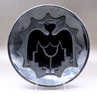 An open black bowl carved with a thunderbird and geometric design
 by Juanita Gonzales of San Ildefonso