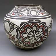 A classic polychrome Zuni jar decorated with a four-panel rosette, rain bird and geometric design
 by Unknown of Zuni