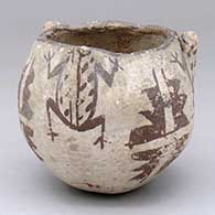 A black-on-white bowl decorated with frog head appliques and a three-panel frog and geometric design
 by Unknown of Zuni