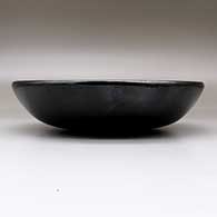 A plain black serving bowl, polished inside and out, with fire clouds, click or tap to see a larger version