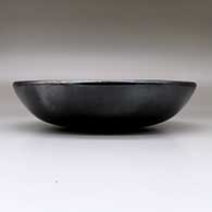 A plain black serving bowl, polished inside and out, with fire clouds, click or tap to see a larger version