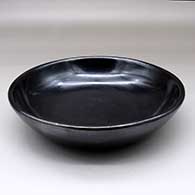 A plain black serving bowl, polished inside and out, with fire clouds
 by Maria Martinez of San Ildefonso